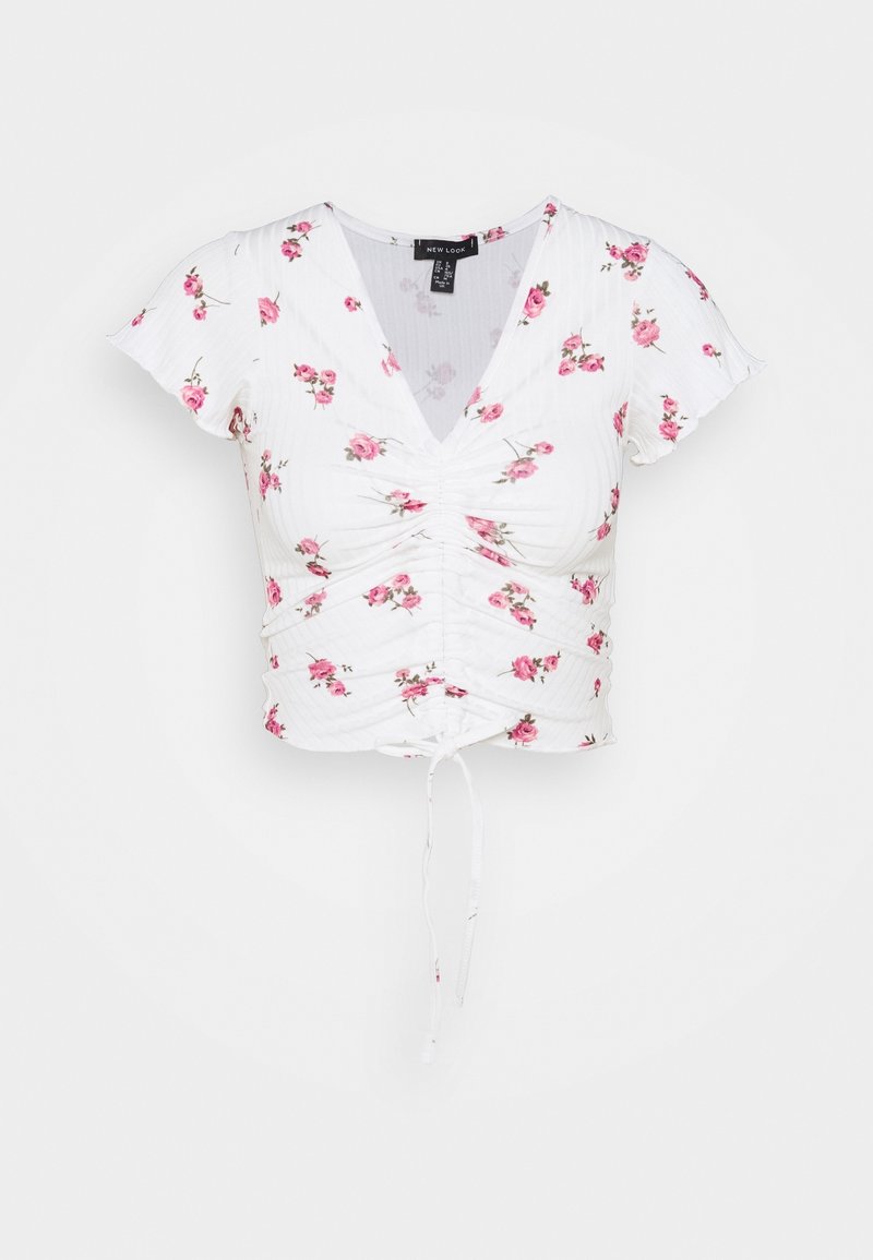 Vit kortärmad topp med rosa blommönster, V-ringning, samlad front och justerbar dragsko i nederkant för passform. Texturerat tyg.