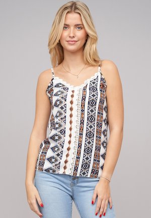 Top en satin à bretelles spaghetti avec un motif géométrique bleu marine, blanc et marron. Présente une bordure en dentelle le long de l'encolure et une coupe décontractée.