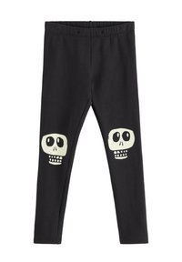 Sorte leggings med en blød tekstur har to hvide skeletdesigns på knæene. Vadeshøjde er elastisk for komfort og nem påklædning.