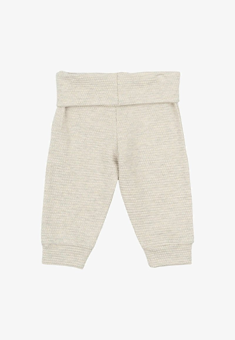 Svetlo bež hlače za otroke, izdelane iz tekstilnega materiala, z širokim elastičnim pasom in zoženimi gležnji. Brez vidnih vzorcev ali okrasnih elementov.