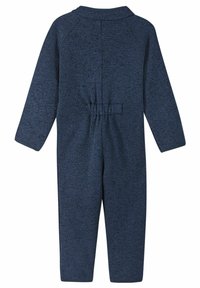 Mörkblå stickad jumpsuit med långa ärmar, elastisk midja och rund halsringning. Texturerat tyg med ett subtilt mönster över hela plagget.
