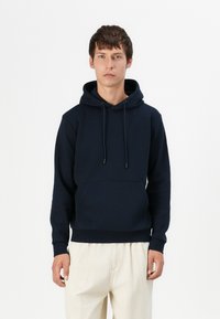 Navy blue hoodie in soft, textured fabric features a drawstring hood, front pocket, and ribbed cuffs and hem. Suitable for casual wear.
