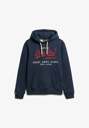 Marineblaue Kapuzenjacke mit verstellbarem Kordelzug, Fronttasche und bedrucktem Text: "Vintage SuperDry" mit Details zu Tokio, Japan und cremefarbenen Akzenten.