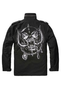 Černá bunda s velkým bílým motivem lebky se špičáky, řetězy a hroty na zádech. Límec a knoflíky ve vojenském stylu.