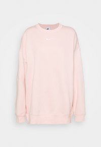 Ljusrosa sweatshirt gjord av mjukt tyg, med rundad halsringning och långa ärmar. Distinkt vitt Nike-logotyp på bröstet.