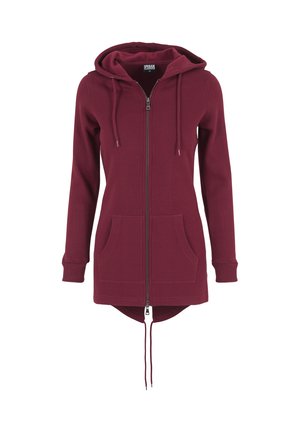 Hanorac zip-up căprui cu glugă ajustabilă, mâneci lungi, buzunare frontale și un tiv posterior ușor mai lung. Material moale și manșete ribbate.