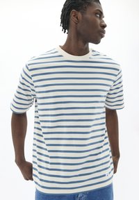 Striped T-shirt, cotton blend, featuring horizontal blue and white stripes, round neck, short sleeves, and a small label at the hem.