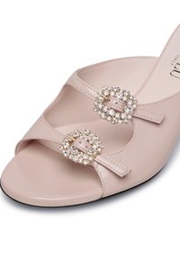 Pink leather open-toe sandals with two crystal-embellished buckles, featuring a smooth texture and a slight heel. Black outsole.