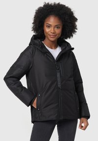 Black padded jacket with a hood, front zip, and snap button pockets. Features a textile brand tag and ribbed cuffs for added warmth.