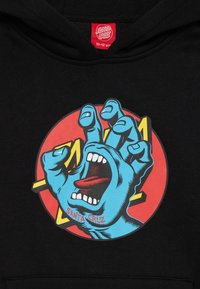 Black hoodie featuring a circular graphic of a blue hand and screaming mouth on a red background, with "SANTA CRUZ" printed below.