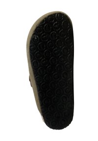 Zwarte rubberen zool met cirkelvormig loopvlakpatroon, grijze stoffen rand, met een platte en textuur voor grip en duurzaamheid.