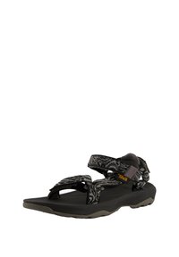 Black and gray Teva sandal featuring patterned nylon straps, adjustable buckles, and a cushioned rubber sole with a textured grip.