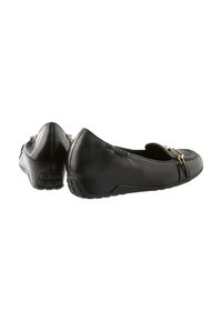 Black leather flats with a round toe, featuring a smooth texture and decorative gold hardware. Rubber sole with grip detailing at the heel.