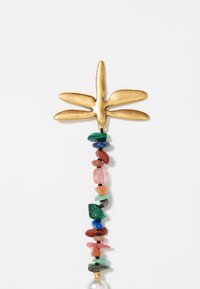 Gold dragonfly-shaped pendant above a colorful bead strand featuring various shapes and materials, including stones and pearls.