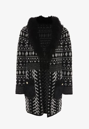 Schwarz-weißer Musterjacke mit einem Kunstfellkragen, geknöpften Taschen und einer lockeren Passform, die geometrische und tribal Designs aufweist.