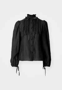 Blouse noire à manches longues avec un col haut à volants, fermeture à boutons sur le devant et rayures texturées. Présente des manches froncées avec des rubans à nouer.