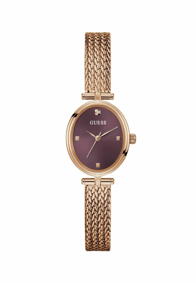 Montre en or rose avec un bracelet texturé et un cadran rond violet foncé, comportant des accents dorés et des index carrés. Nom de la marque affiché.