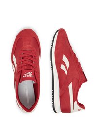 Punased spordijalatsid, mille ülemine osa on valmistatud nahast ja võrgust, valgete aktsentidega, paeladega ja tekstureeritud musta tallaga. Reeboki logo keelal.