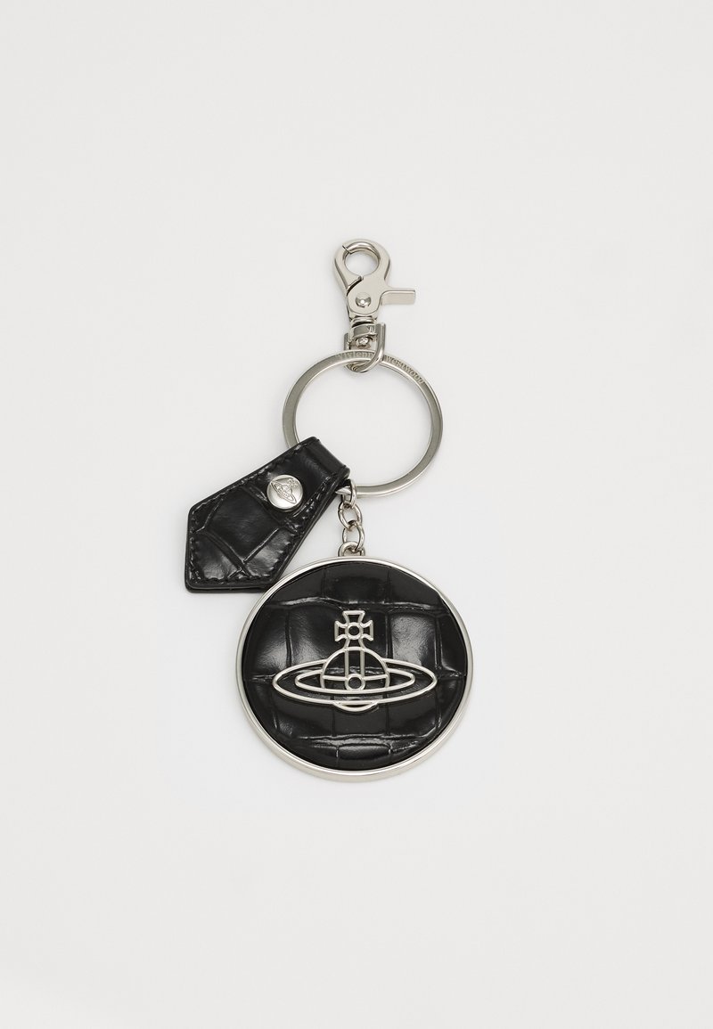 Black leather keychain with a round, textured pendant featuring a silver emblem, attached to a metal keyring and clip.