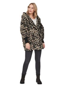 Panterprint oversized hoodie in zachte, harige stof. Heeft een diepe V-hals, grote capuchon en zwarte geribde manchetten. Gemaakt om over een witte top en jeans te dragen.