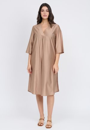 Light brown dress made of smooth fabric, featuring a v-neck, three-quarter sleeves, and side slits for ease of movement.