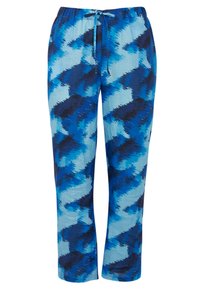 Blauwe gestreepte broek met een elastische tailleband en trekkoord. De stof heeft een golvend design in verschillende tinten blauw en zwart.