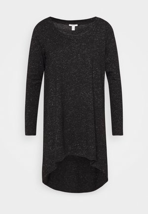 Langarm-Tunika in Schwarz, aus einem strukturierten Strickstoff mit dezenten weißen Punkten. Abgerundeter Saum, hinten etwas länger.