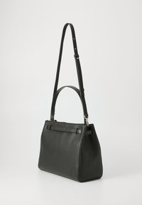Black leather handbag with a structured shape, featuring a detachable shoulder strap, metal accents, and a textured finish.