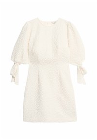 Bílé šaty se strukturovanou tkaninou, krátkými vypufovanými rukávy s mašlí a přiléhavým siluetam.