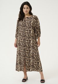 Vestido de estampado de leopardo en beige y negro, de manga larga, corte holgado, con una abertura hasta la rodilla, tejido ligero, con escote redondo y detalle de lazo.
