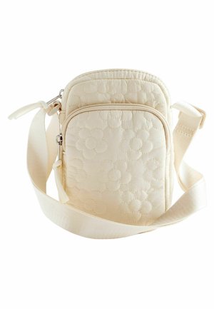Sac bandoulière matelassé crème avec motif floral, sangle réglable, compartiments à double zip, et texture lisse.