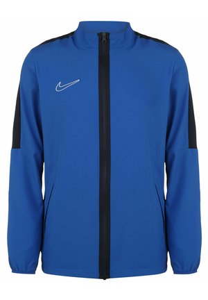 Blaue Nike-Jacke mit durchgehendem Reißverschluss, hohem Kragen und schwarzen Akzenten an den Schultern. Hergestellt aus leichtem, glattem Material.