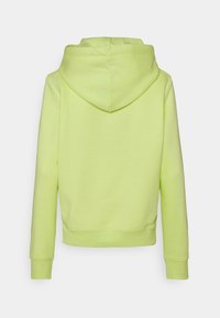 Felpa con cappuccio in un vivace verde lime, caratterizzata da una texture morbida, polsini a coste e un design con tasca a marsupio, con orlo corto.