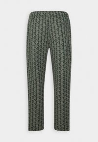 Pantalon vert foncé avec une taille élastique et un motif géométrique clair répétitif couvrant l'ensemble du tissu.