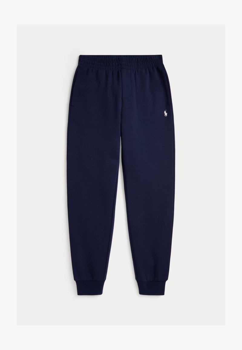 Pantalon de survêtement bleu marine avec taille et poignets élastiques, poches latérales et petit logo blanc brodé sur la cuisse gauche.