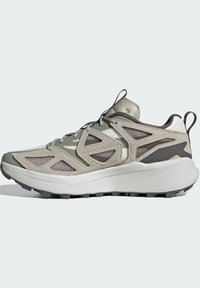 Light grey hiking shoes with a mesh upper, distinctive triangular cutouts, gray accents, and a textured sole for traction.