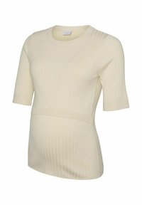 Top premaman a coste in beige cremoso. Presenta maniche corte, scollatura rotonda e un design aderente per il massimo comfort durante la gravidanza.