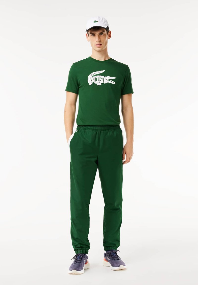 Lacoste Sport BLOCK Tracksuit bottoms vert bleu marine blanc/green