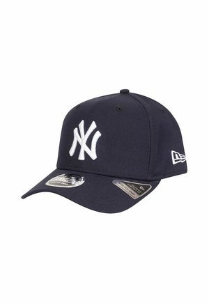Navy blue baseball cap with a white embroidered logo, solid construction, curved bill, and stretch-snap back for adjustable fit.