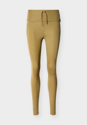 Leggings beige taille haute avec cordon de serrage à l'avant et coupe slim, présentés sur un fond clair uni.