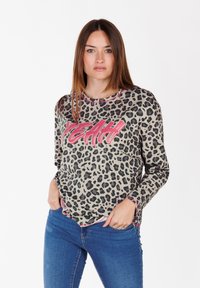 Long-sleeve shirt in beige with black leopard print, featuring a pink "YEAH" graphic across the front and contrasting trim along the neckline.