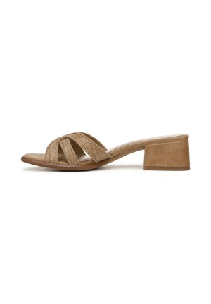 Beige suède sandaal met blokhak en gekruiste bandjes. Textuur bovenwerk met een gladde binnenzool. Lage, stevige hak voor stabiliteit.