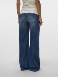 Wide-leg blue denim jeans featuring a high waist, two back pockets, and a slightly faded texture. The fabric is thick and sturdy.