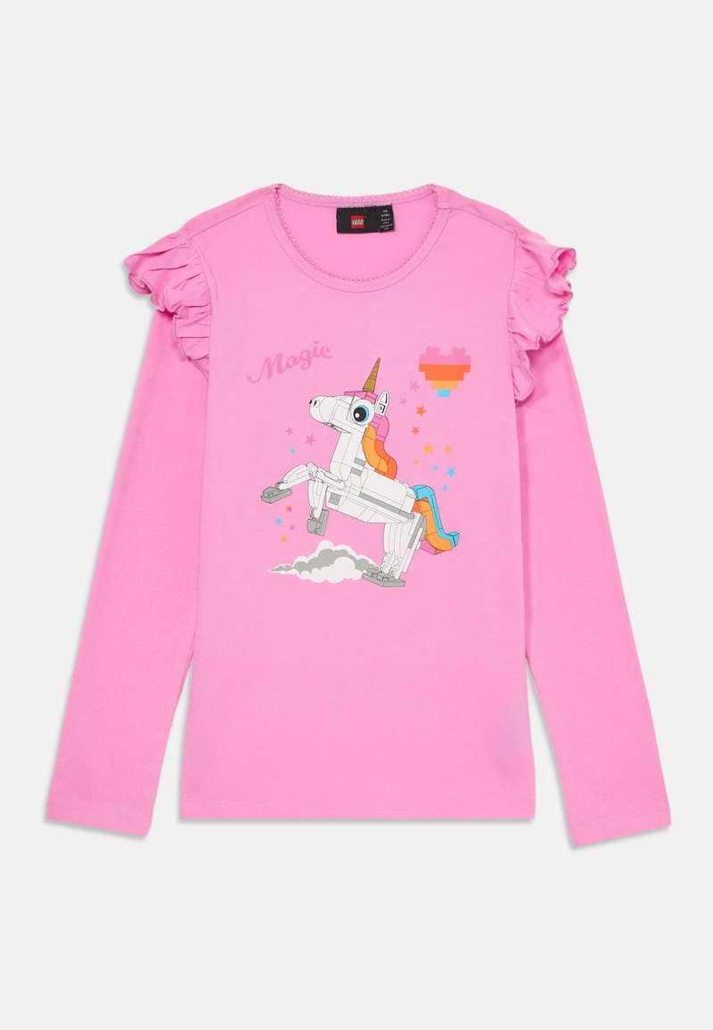 Rózsaszín, hosszú ujjú ing fodros vállakkal, LEGO-stílusú unikornissal, színes csillagokkal, pixeles szívvel és a "Varázslat" szóval.