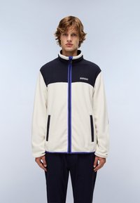 Giacca in pile con una parte superiore blu navy e una parte inferiore crema. Dotata di una cerniera completa, due tasche frontali e dettagli blu.