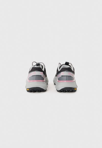 Black and gray hiking shoes with pink accents, reflective details, textured soles, and a padded collar for comfort. Durable design for outdoor use.