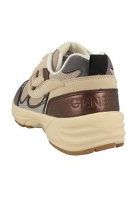 Sneaker featuring a cream and brown design, with textured mesh and leather accents, rounded shape, and a contrasting black heel tab.