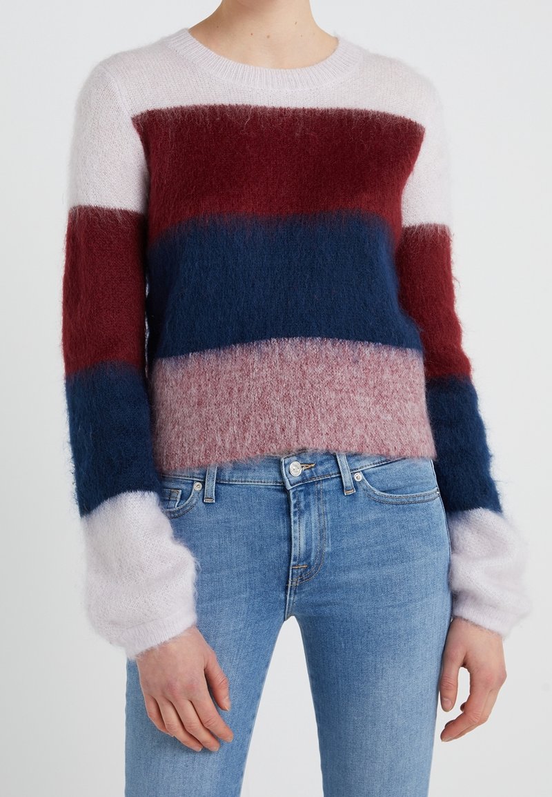 Pull en maille avec des rayures horizontales en bordeaux, marine, rose et blanc. Texture douce et moelleuse avec un col rond et des manches longues.