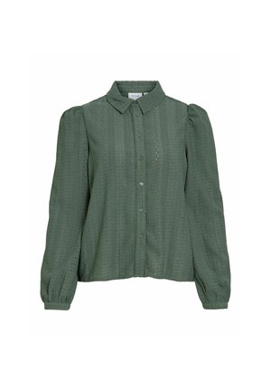 Blouse verte à manches longues avec boutons, tissu texturé, épaules bouffantes et col classique.