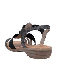 Schwarze Sandalen verfügen über geflochtene Canvas-Riemen und eine gepolsterte Innensohle. Der Absatz ist etwa 2,5 cm hoch und die Sohle ist leicht und flexibel.